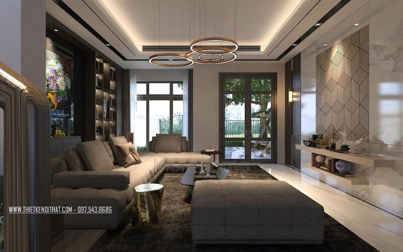 Phòng khách hiện đại sắc trầm nhưng rộng rãi, thông thoáng với cửa sổ, cửa chính kính lớn. Thiết kế nội thất phòng khách nhà phố