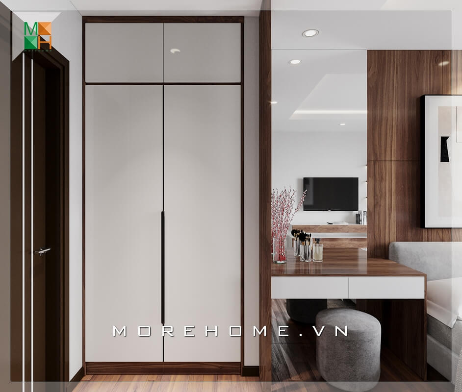 Mẫu tủ quần áo phòng ngủ thiết kế âm tường kịch trần kết hợp với bàn trang điểm và sofa đôn bọc nhung rất hiện đại khiến căn phòng ngủ chung cư, nhà phố trở nên tiện nghi và hiện đại hơn. Thiết kế chung cư hiện đại