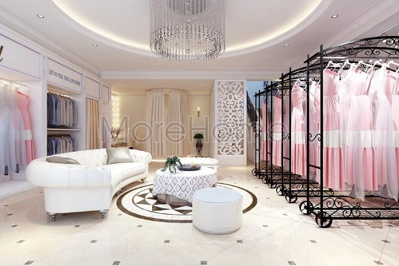 Thiết kế nội thất showroom áo cưới Calla Lily cao cấp với sự có mặt của bộ sofa da màu trắng cùng với thanh treo quần áo màu đen tạo điểm nhấn nổi bật cho không gian căn phòng